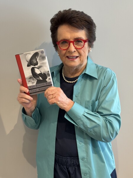 Tennis legend and women's equality activist, Billie Jean King, holding Toni Morrison's "The Bluest Eye"